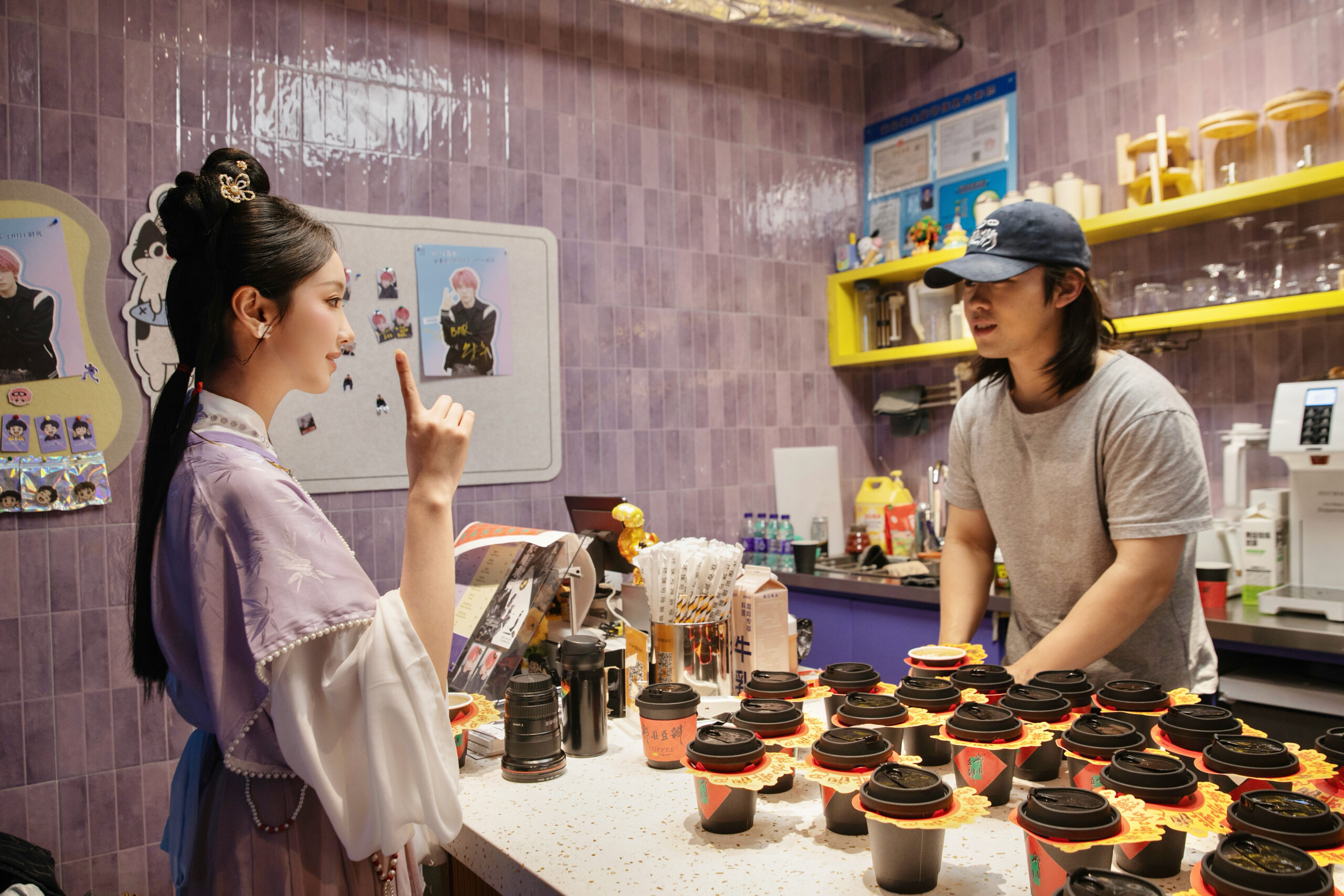 Un visiteur communique avec un barista pendant qu'il prépare du café infusé avec de la pâte de fèves Pixian sur le lieu d'enregistrement de la nouvelle émission télévisée.