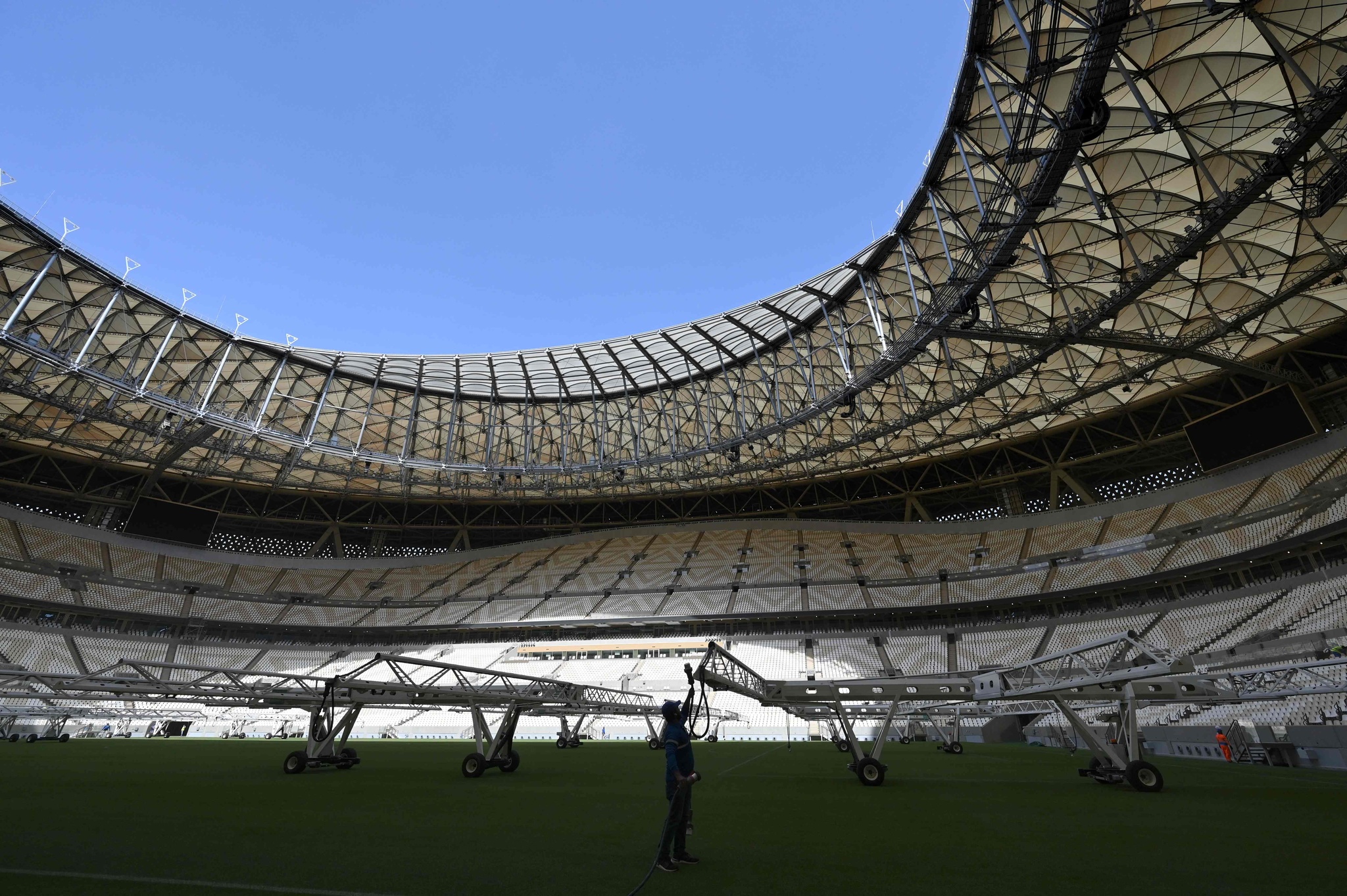 Un homme travaille sur le terrain du Lusail Stadium, le stade d'une capacité de 80 000 places qui a accueilli la finale de la Coupe du Monde de la FIFA 2022, à la périphérie de Doha, la capitale du Qatar, le 28 mars 2022. /VCG