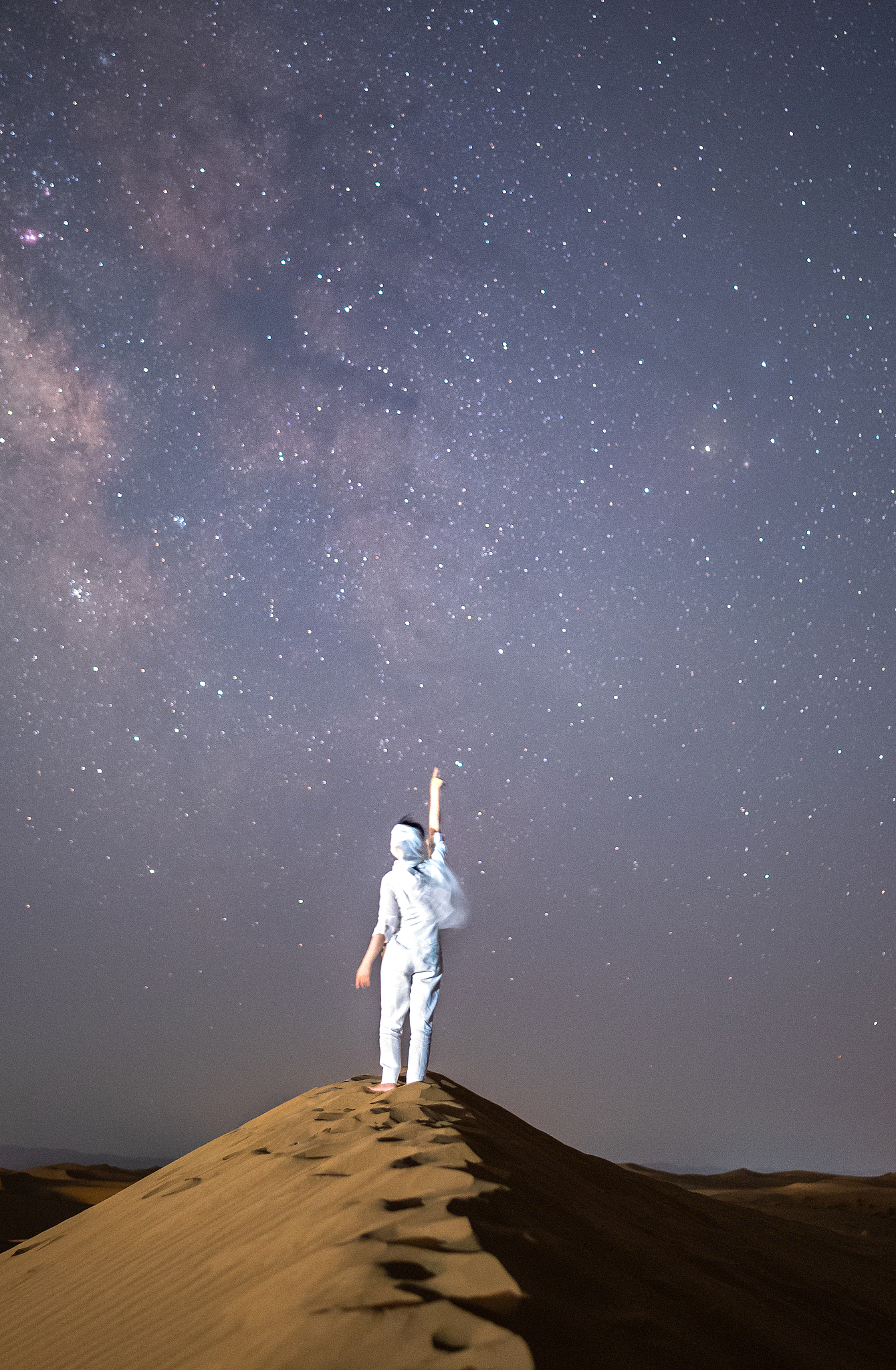 Une photo d'archive montre un visiteur regardant les étoiles dans la zone panoramique de Shapotou, dans la ville de Zhongwei, dans la région autonome du Ningxia Hui, dans le nord-ouest de la Chine. /VCG
