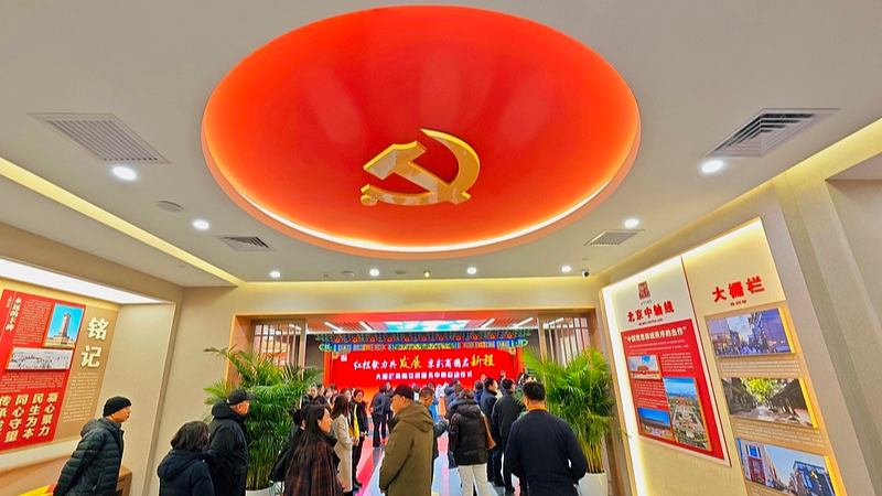 Des visiteurs visitent le Dashilan Beijing Fang Business Circle Party-Mass Service Center, un centre de gouvernance et de services publics au niveau communautaire dans le district de Xicheng à Pékin, en Chine, le 10 décembre 2025. /VCG